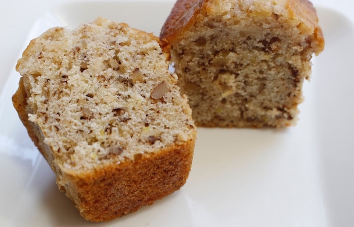 Very moist mini lemon walnut cake, sliced to reveal its soft, tender texture.